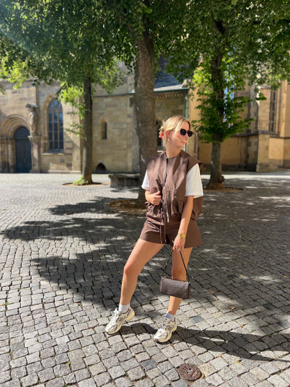 Model trägt die Julia Weste und Julia Shorts in Dunkelbraun von Dutch Atelier, stilvolles Set mit moderner Passform.